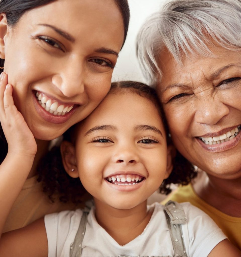 Happy mom with child, grandmother smile for portrait and young girls family in Mexico home together